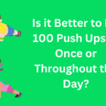 Two Animated Characters Doing Push Ups and the Text, "Is it Better to Do 100 Push Ups at Once or Throughout the Day?"