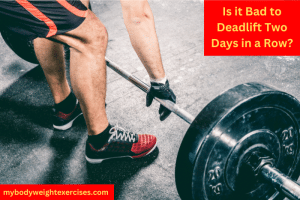 A Man's Legs and a Loaded Barbell on the Floor. He is Preparing to Deadlift