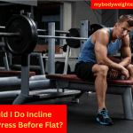 An Athletic Man Sittng on the Bench of the Bench Press Resting Between Sets