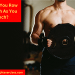A Muscular Man Holding a Heavy Weight Plate