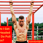 A Muscular Man Doing Pull Ups on an Outdoor Bar
