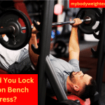 A Man Performing the Bench Press in a Gym